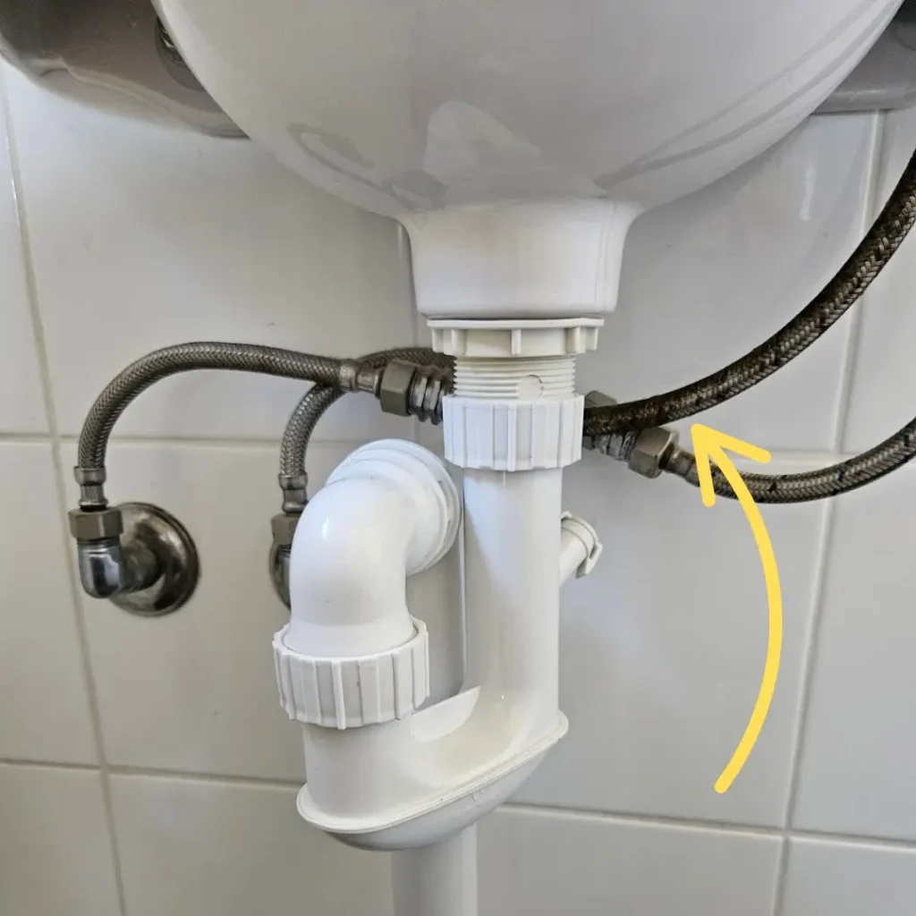 Braided flexi pressure pipe under a sink - Coast Runner Plumbing and Gas Perth