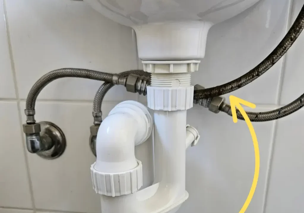 Braided flexi pressure pipe under a sink - Coast Runner Plumbing and Gas Perth